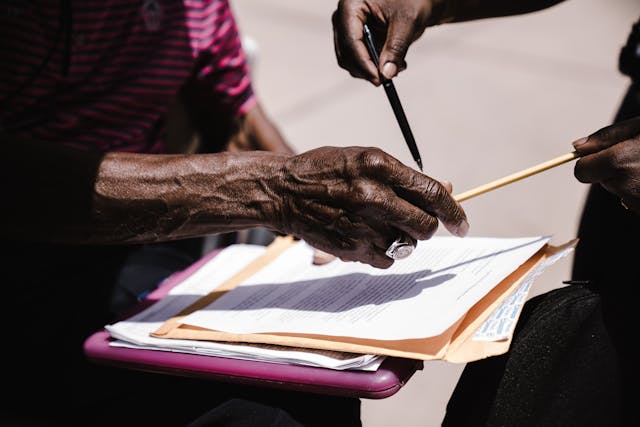 two peole signing a document